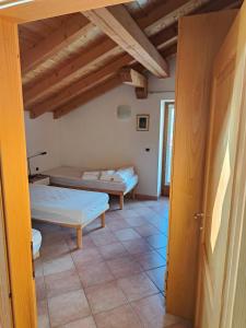 a bedroom with two beds in a room at Mansarda Belvedere in Molveno