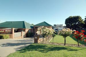 a fence with two trees in a yard at Poachers Paradise in Rutherglen +7 photos