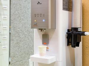 a bathroom with a toilet with a cup on it at APA Hotel Kyoto Eki Horikawadori in Kyoto