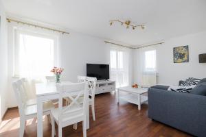 a living room with a table and a couch at ShortStayPoland Tomcia Palucha B118 in Warsaw +11 photos