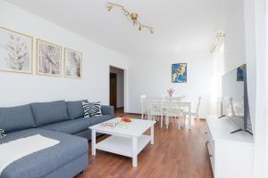a living room with a blue couch and a table at ShortStayPoland Tomcia Palucha B118 in Warsaw