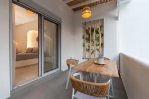 a room with a table and chairs and a bed at IOSIF LUXURY ROOMS CENTER in Neos Marmaras