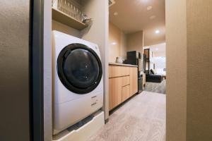 a laundry room with a washer and dryer at stayme THE HOTEL Ueno Ekimae in Tokyo +39 photos