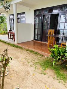 a porch of a house with a wooden deck at Saveen View Ella in Ella