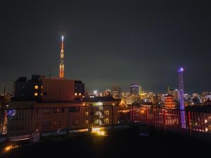 a view of a city skyline at night at hotel MONday Asakusa in Tokyo