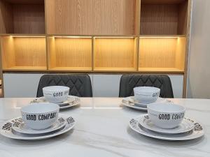 three cups and saucers sitting on a table at Căn Hộ 2 Phòng Ngủ Tại The Matrix One in Hanoi