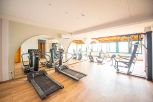 a gym with several treadmills and ellipticals at Baia Taormina - CDSHotels in Forza dʼAgro