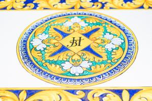 a blue and yellow plate with a star on it at Baia Taormina - CDSHotels in Forza dʼAgro
