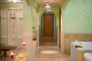 a bathroom with a tub and a shower and a sink at Baia Taormina - CDSHotels in Forza dʼAgro