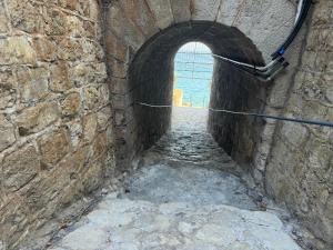 an alley way with an archway in a brick wall at Baia Taormina - CDSHotels in Forza dʼAgro