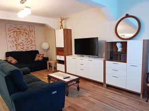 a living room with a couch and a tv at Bellavista in Santander