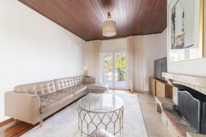 a living room with a couch and a fireplace at Portuguese Luxury Villa in Setúbal