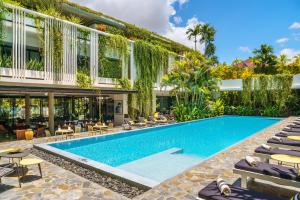 an image of a pool at a hotel with lounge chairs at Viroth's Hotel in Siem Reap