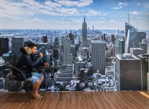 a man sitting at a table in front of a city skyline at Olinda Home in Olinda