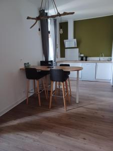 a kitchen with a wooden table and chairs at Monette in Condom