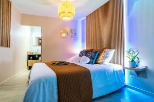 a bedroom with a large bed in a room at L'Amour d'Or Centre Historique in Besançon +20 photos