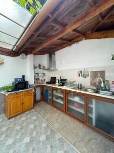 a large kitchen with wooden cabinets and stainless steel appliances at Sarievi Holiday Home in Tsarevo
