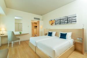 Postel nebo postele na pokoji v ubytování Cityloog Hotel Tebet Jakarta