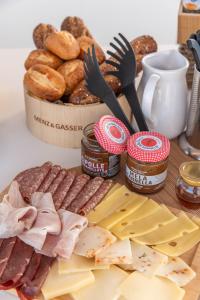 a table topped with cheese and meats and other foods at Palazzo Arco Cadura Hotel & Spa in Galatina