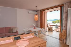 a living room with a couch and a table at Favolabella The Loft in Bardolino