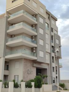 a building with balconies on the side of it at Sublime appartement le Palace Hammamet Nord Mrezga - Family only in Hammamet