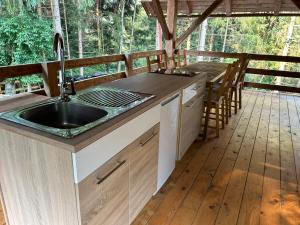a kitchen with a sink on a deck at The BeeHouse, Nature stay in Šempeter v Savinjski Dolini