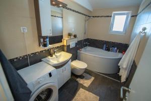 a bathroom with a sink and a tub and a toilet at Mantra HOME in Bar +48 photos