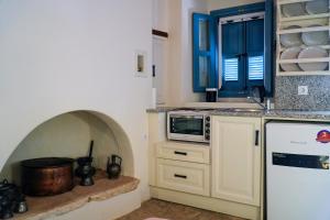 a kitchen with a refrigerator and a stove top oven at Symi Uptown Carmine in Symi