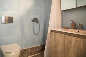 a bathroom with a shower and a toilet and a sink at Symi Uptown Carmine in Symi