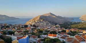 an aerial view of a town with a mountain at Symi Uptown Carmine in Symi