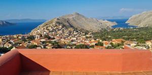 a view of a small town on a mountain at Symi Uptown Carmine in Symi
