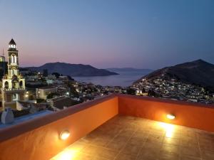 a view of a city from a balcony at night at Symi Uptown Carmine in Symi