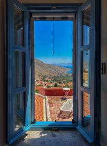 an open window with a view of a balcony at Symi Uptown Carmine in Symi