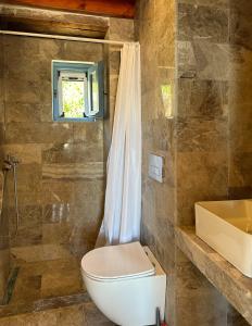 a bathroom with a toilet and a sink at Symi Uptown Carmine in Symi