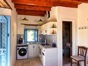 a kitchen with a washer and dryer in it at Symi Uptown Carmine in Symi