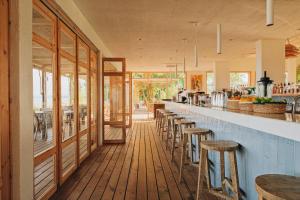 a restaurant with a long bar with stools at Nayu Igneada in Demirköy