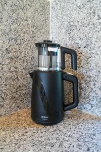 a black blender sitting on top of a counter at Symi Uptown Carmine in Symi