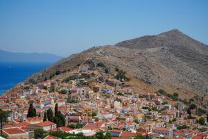 a town on the side of a mountain at Symi Uptown Carmine in Symi