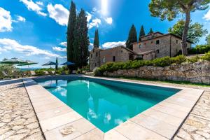 a swimming pool in front of a house with a building at Bellaria Apartments - Chianti View, Swimming Pool, Nature in San Sano