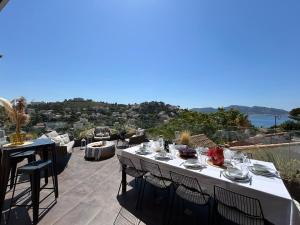 a table with plates of food on top of a patio at Maï Homes - La Villa Bompard in Marseille