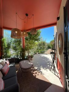 a living room with a couch and a table at Maï Homes - La Villa Bompard in Marseille