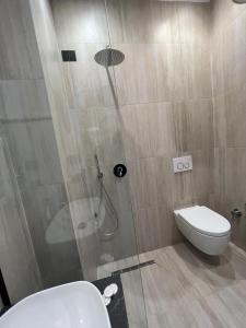 a bathroom with a shower and a toilet at Hotel Harper Durres in Durrës