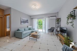 un salon avec un canapé et une table dans l'établissement P Deluxe Suites A4, à Néa Michanióna