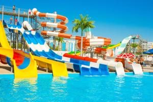 a water park with a slide in the water at River Side in Aktobe