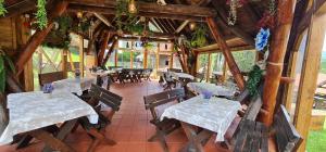 an empty restaurant with tables and chairs in a building at Vila Evergreen in Predeal