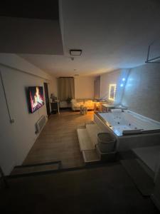 a view of a living room from the top of a building at Loft ravissant 45m2 Jacuzzi RVB NIGHT 2 ÉTABLISSEMENT FERMÉ DÉFINITIVEMENT in Amiens