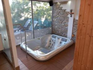 a bath tub in a room with a window at Apartments Ruzica in Pinezici +17 photos