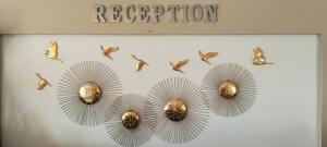 a group of birds flying over a white wall at Hotel City Palace in Brahmapur