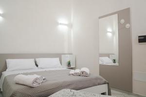 a bedroom with a bed with towels on it at La Loggia Suite in Marsala