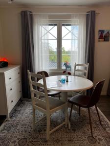 a table and chairs in a room with a window at Moonloft@VillaSolbacka in Inkoo